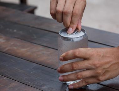 Soda been shaken up tapping the lid does nothing tapping the side prevents bubble building and soda explosion