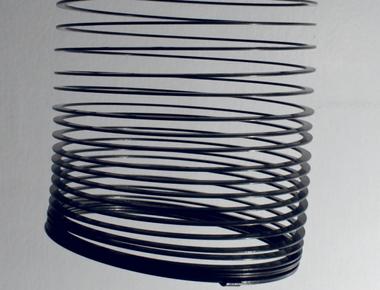 If you stretch a standard slinky out flat it measures 87 feet long