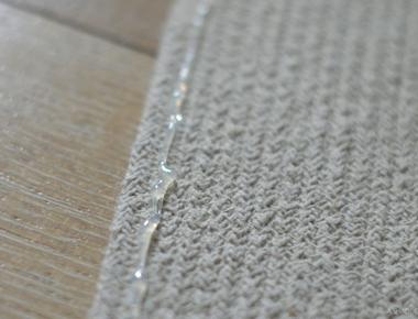 Make your rugs non slip by adding a line of caulk on the bottom