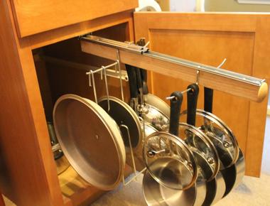 Avoid clutter by hanging pots and pans inside cabinet doors