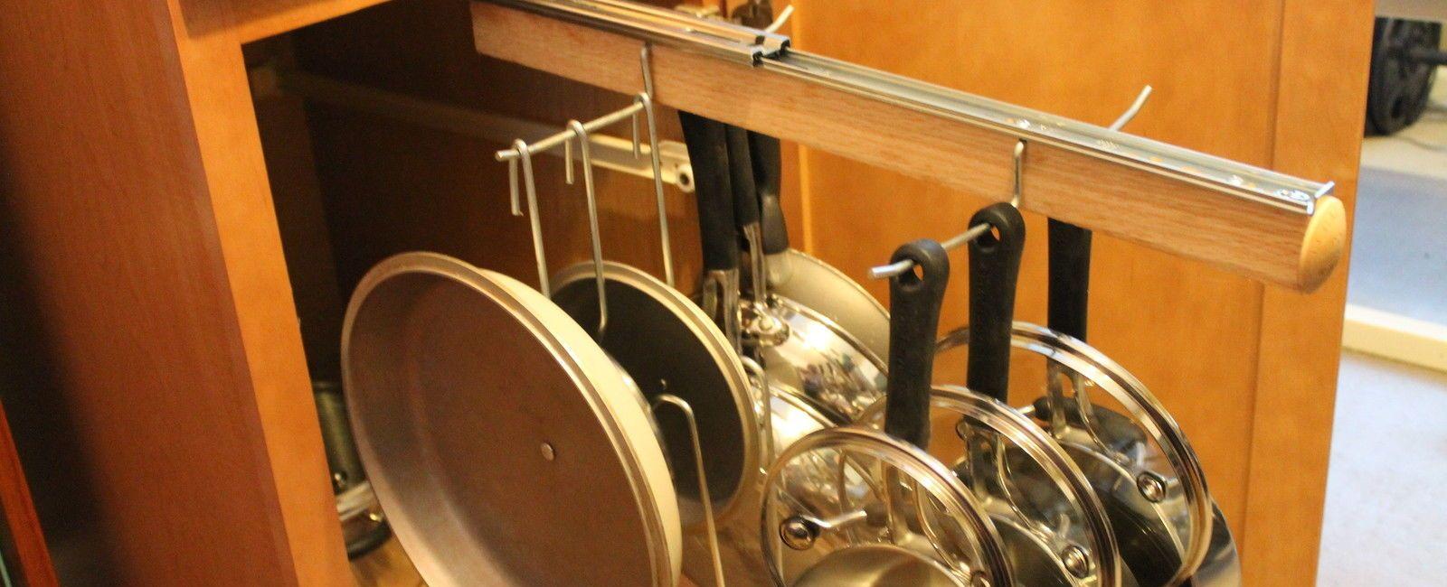 Avoid clutter by hanging pots and pans inside cabinet doors