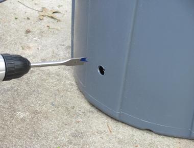 Drill a hole in the bottom of your trash can to keep bags from sticking