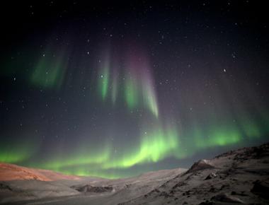 Scientists are now sure that the aurora borealis is caused by solar winds entering the earth s atmosphere its electrons and protons hit particles in the atmosphere that release energy that causes the northern lights