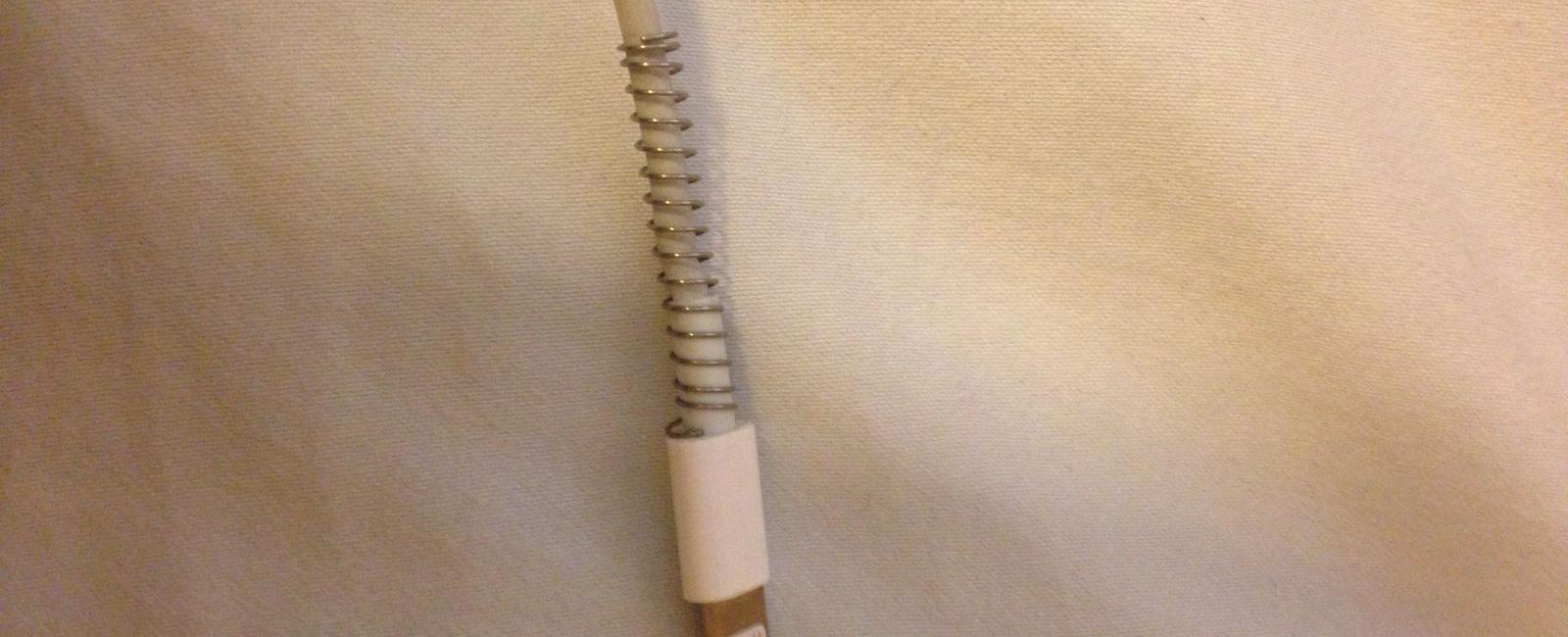 Use a spring from an old pen to keep your charger from bending or breaking