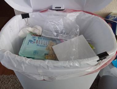 Add some paper to the bottom of your trash bag to keep liquids from leaking out