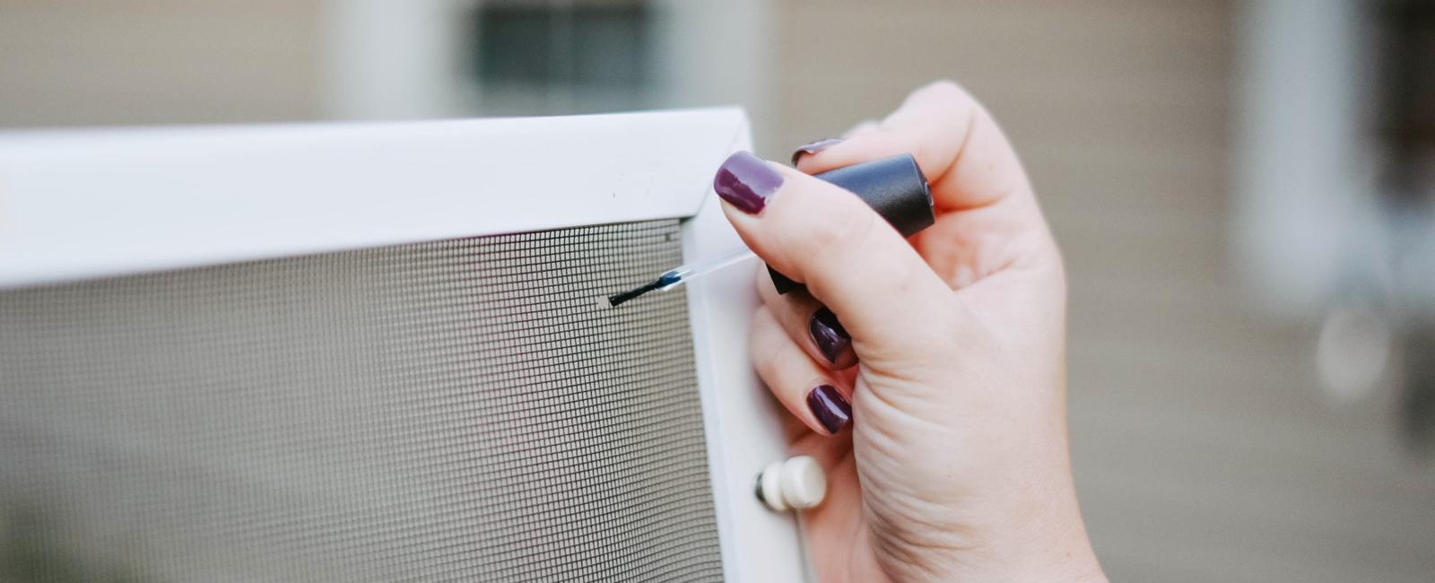 Fix a hole in a window screen with clear nail polish